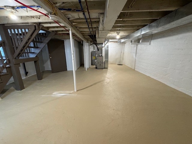 basement featuring water heater and heating unit