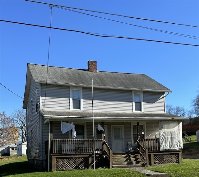 farmhouse-style home featuring covered porch and a front lawn