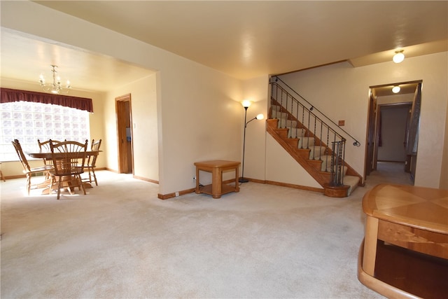 carpeted living room with an inviting chandelier