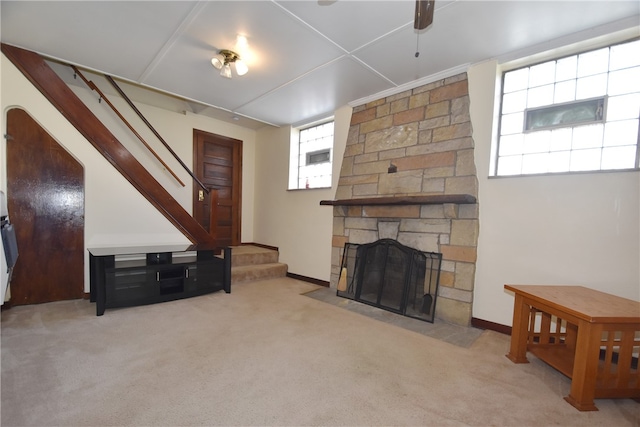 living room featuring a fireplace and light carpet