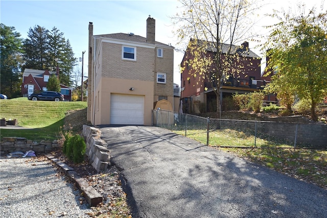 view of home's exterior featuring a garage and a lawn