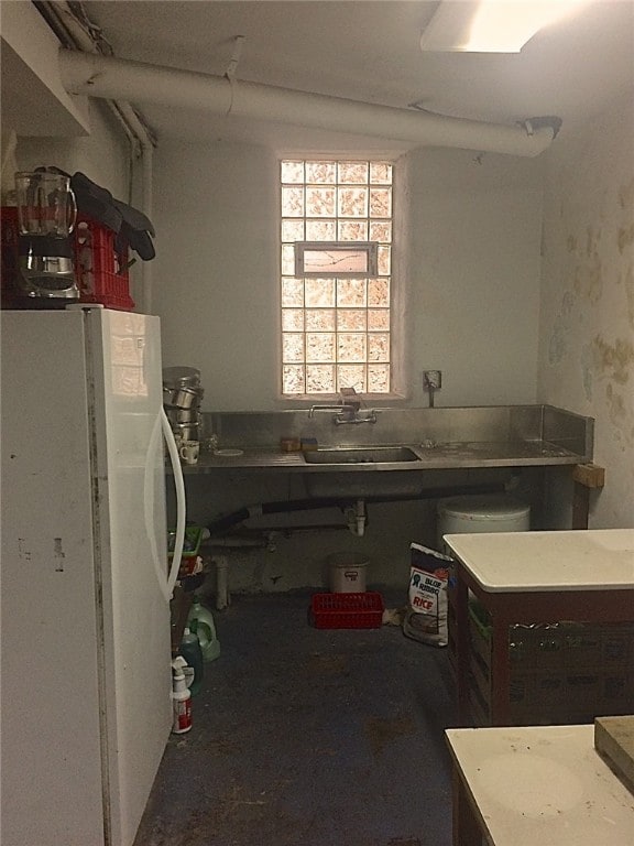 kitchen featuring sink and white fridge