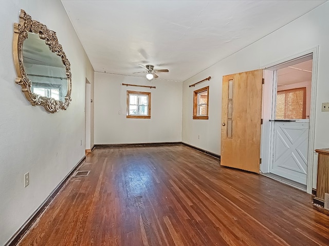 spare room with ceiling fan and dark hardwood / wood-style floors