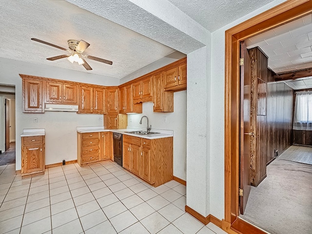 kitchen with ceiling fan, a textured ceiling, dishwasher, light tile patterned flooring, and sink