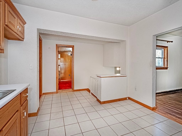 kitchen featuring light hardwood / wood-style flooring and a textured ceiling