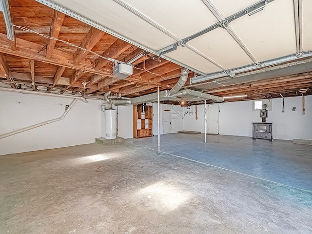 garage featuring a garage door opener and gas water heater