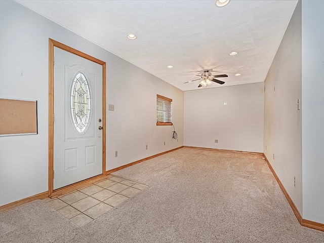 entryway featuring light colored carpet and ceiling fan