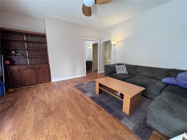 living room with light hardwood / wood-style flooring and ceiling fan