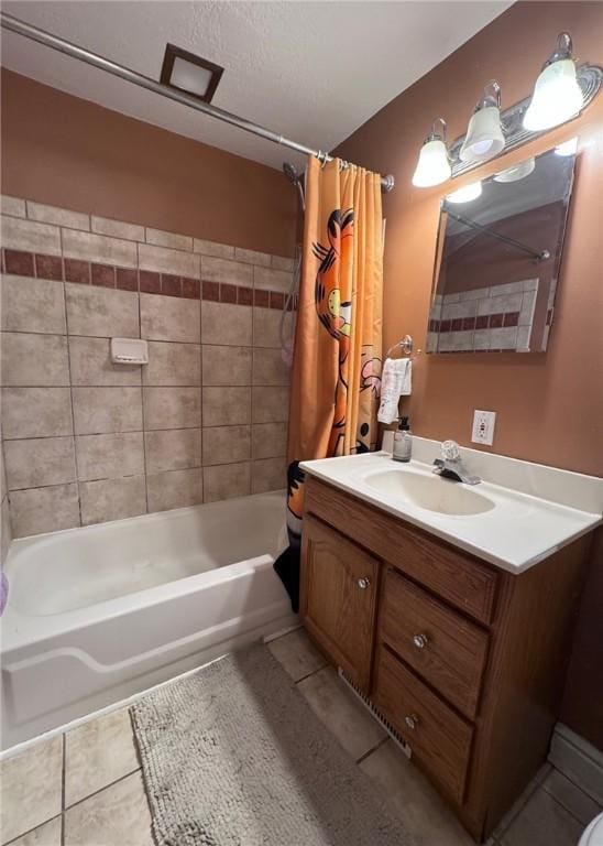 bathroom with tile patterned floors, vanity, a textured ceiling, and shower / tub combo with curtain