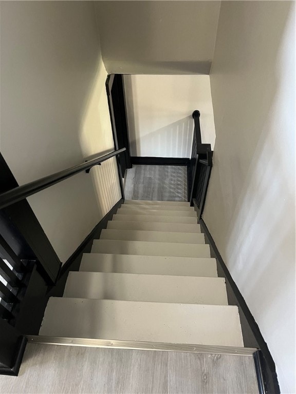 stairs featuring wood-type flooring