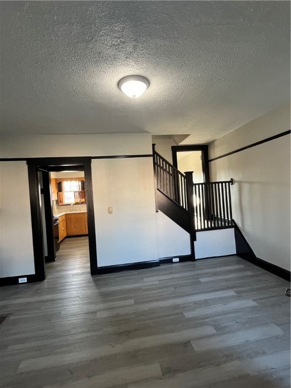 interior space featuring a textured ceiling and wood-type flooring