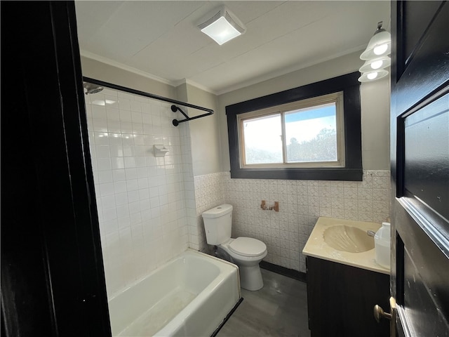 full bathroom with tile walls, crown molding, vanity, tiled shower / bath combo, and toilet