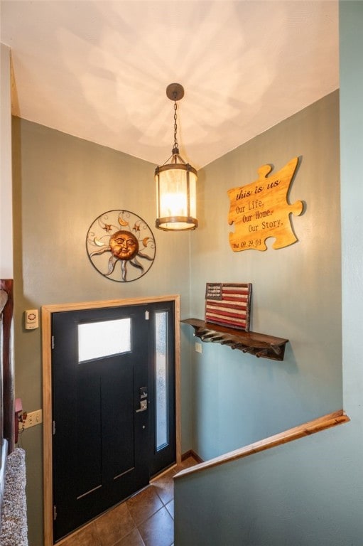 entryway featuring dark tile patterned floors