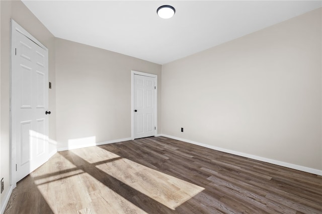 empty room featuring dark hardwood / wood-style flooring