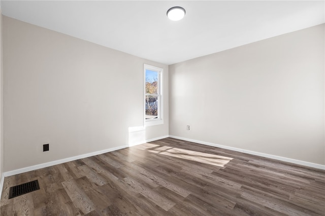 unfurnished room featuring dark wood-type flooring