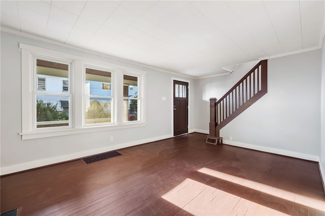 entryway with ornamental molding and dark hardwood / wood-style flooring