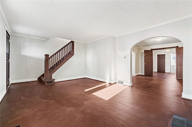 unfurnished living room with ornamental molding and dark hardwood / wood-style flooring