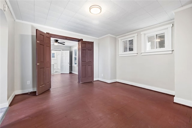 empty room featuring ornamental molding, ceiling fan, and dark hardwood / wood-style flooring