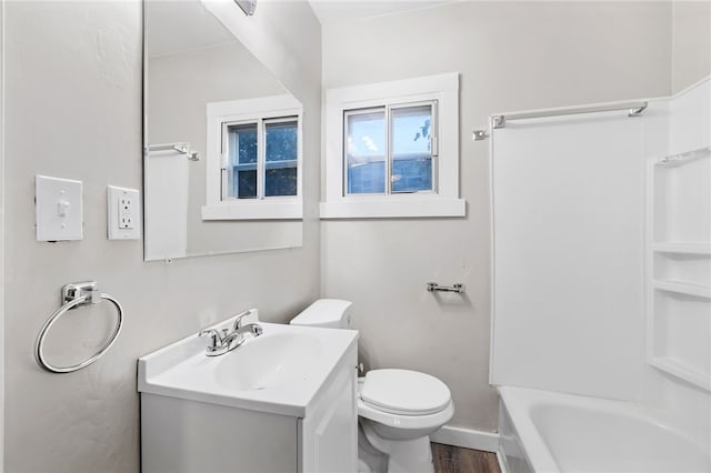 full bathroom featuring vanity, toilet, wood-type flooring, and washtub / shower combination