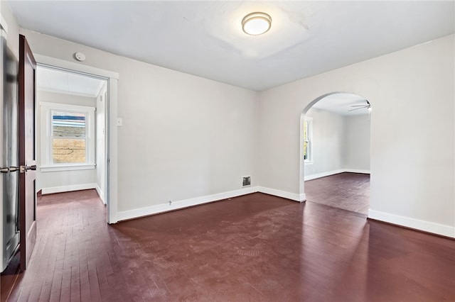 unfurnished room featuring ceiling fan and dark hardwood / wood-style flooring