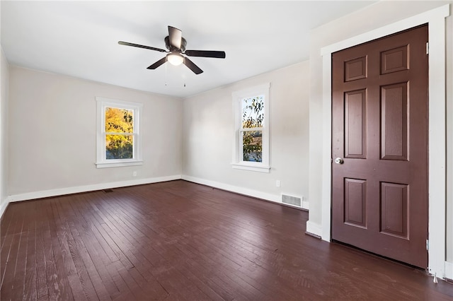 spare room with dark hardwood / wood-style floors and ceiling fan