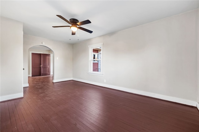 empty room with dark wood-type flooring and ceiling fan