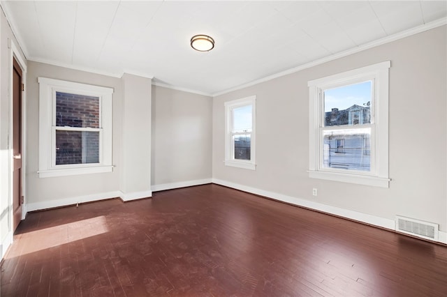 spare room with crown molding and dark hardwood / wood-style flooring