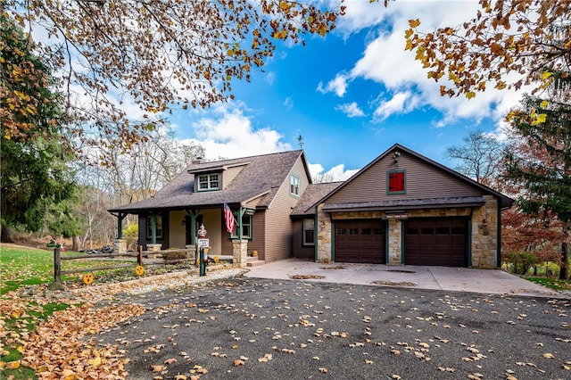 view of front of property with covered porch and a garage