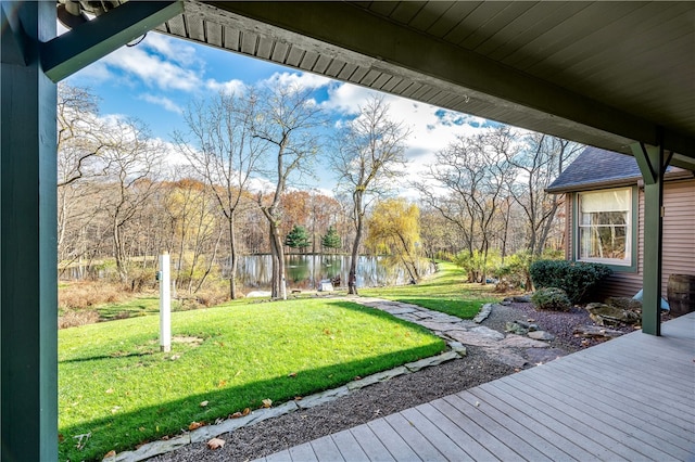 view of yard with a deck with water view