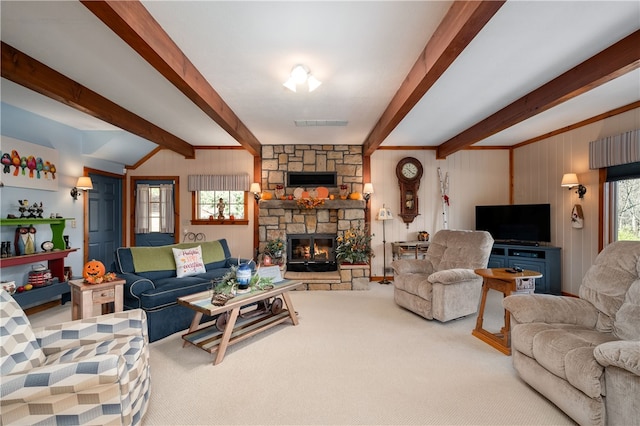 living room with beam ceiling, a fireplace, and carpet