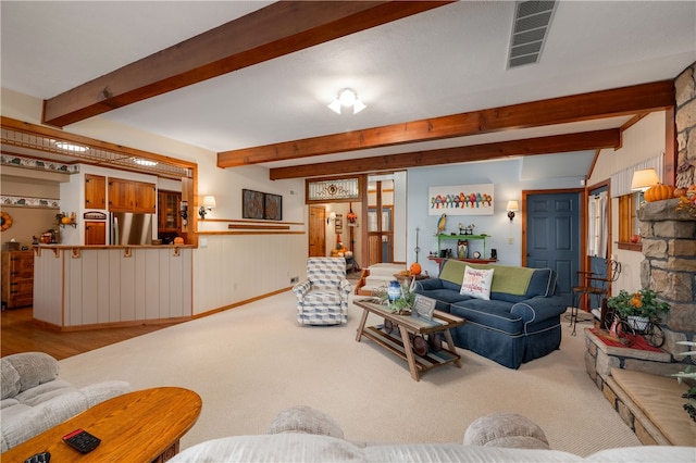 living room featuring light hardwood / wood-style flooring and beamed ceiling