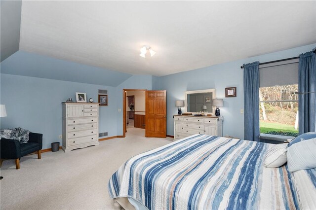 carpeted bedroom featuring lofted ceiling