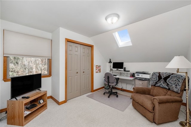 office featuring light carpet and lofted ceiling with skylight