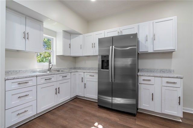 kitchen featuring white cabinetry, stainless steel fridge, sink, and dark wood-type flooring