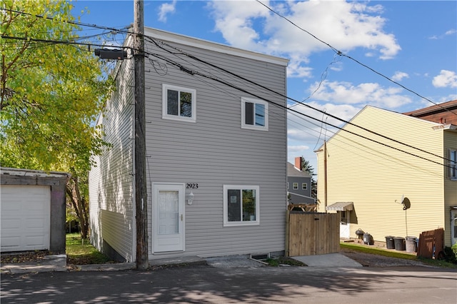 rear view of property with a garage