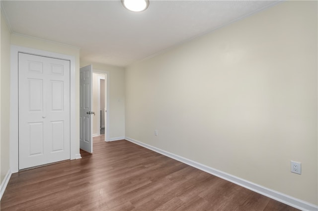 unfurnished bedroom with a closet and hardwood / wood-style floors