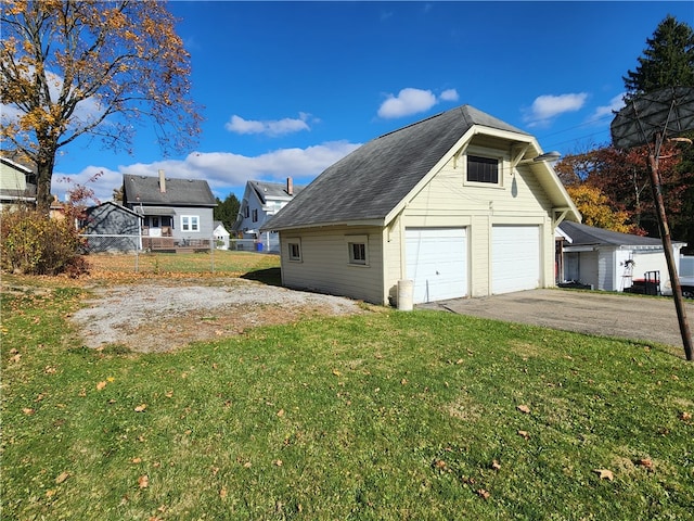 view of property exterior featuring a garage and a lawn