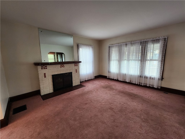 unfurnished living room with carpet and a brick fireplace