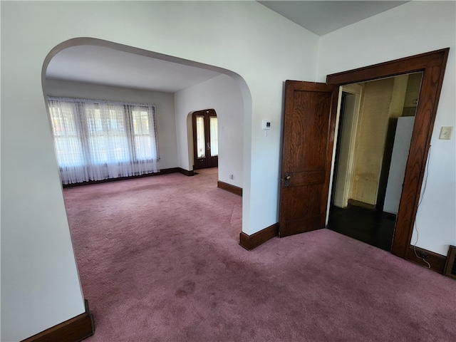 carpeted empty room featuring french doors