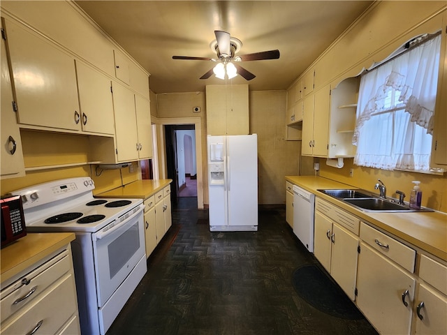 kitchen featuring sink, white cabinetry, and white appliances