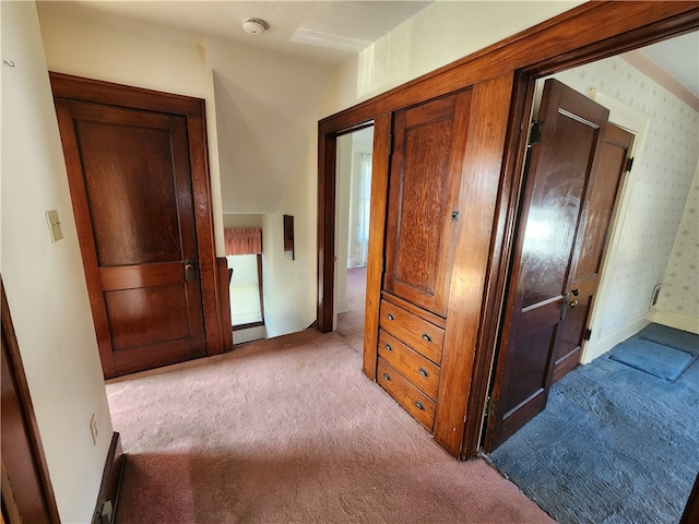 hall featuring light colored carpet