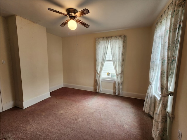 carpeted spare room featuring ceiling fan