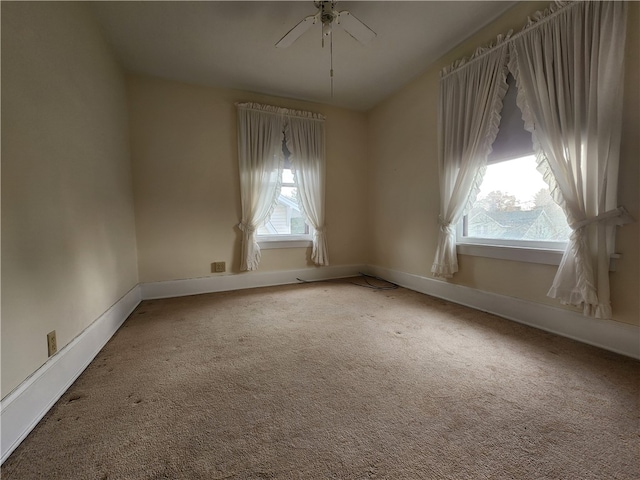 spare room featuring ceiling fan, carpet flooring, and plenty of natural light