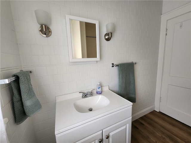 bathroom featuring vanity, tile walls, and hardwood / wood-style floors