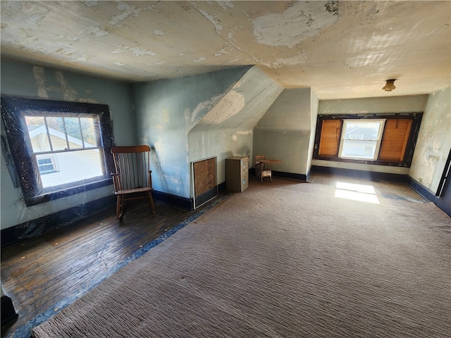 bonus room featuring dark wood-type flooring and vaulted ceiling