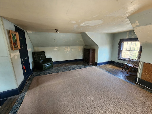 additional living space with lofted ceiling and dark carpet