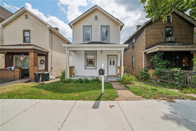 front of property featuring a porch and a front lawn