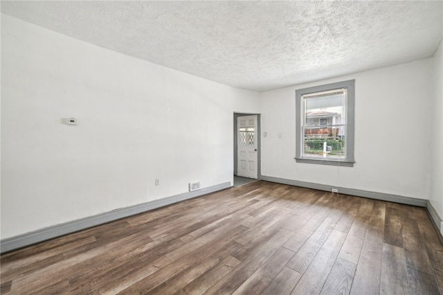 empty room featuring hardwood / wood-style floors and a textured ceiling