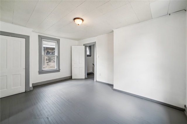 empty room featuring dark wood-type flooring