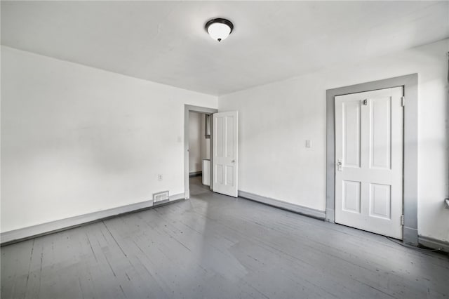 unfurnished room featuring wood-type flooring